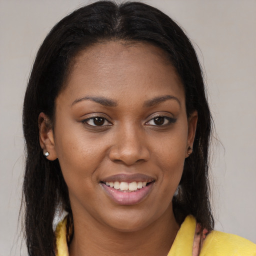 Joyful black young-adult female with medium  brown hair and brown eyes