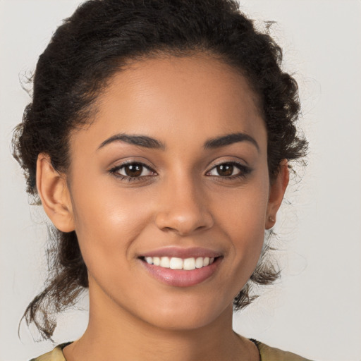 Joyful latino young-adult female with long  brown hair and brown eyes