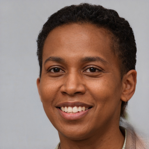 Joyful black young-adult female with short  brown hair and brown eyes