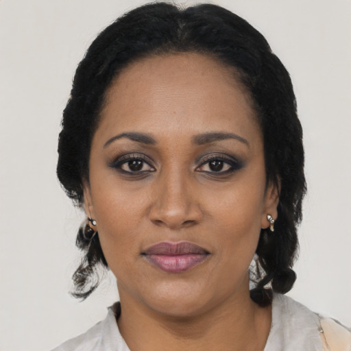 Joyful black adult female with medium  black hair and brown eyes