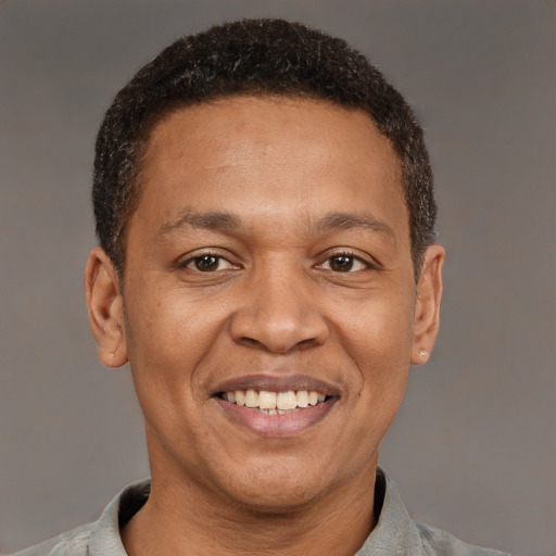 Joyful latino adult male with short  brown hair and brown eyes