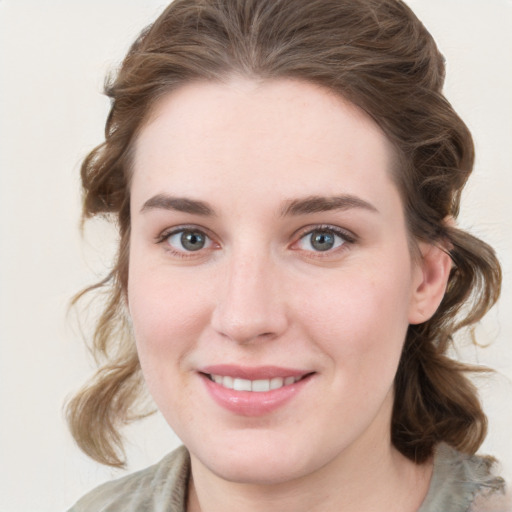 Joyful white young-adult female with medium  brown hair and blue eyes