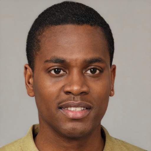 Joyful black young-adult male with short  brown hair and brown eyes
