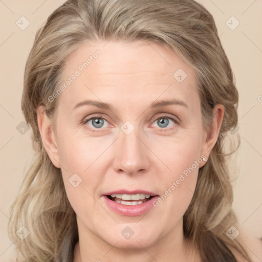 Joyful white adult female with medium  brown hair and blue eyes