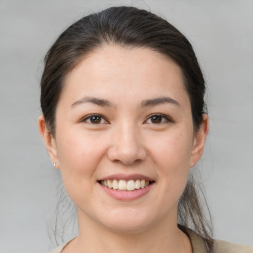 Joyful white young-adult female with medium  brown hair and brown eyes