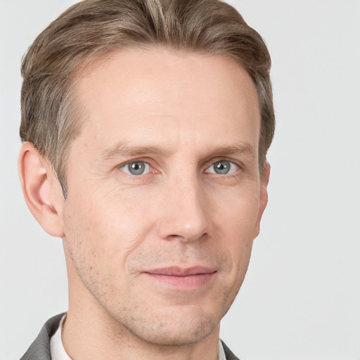 Joyful white adult male with short  brown hair and grey eyes