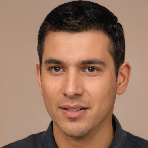 Joyful white young-adult male with short  black hair and brown eyes