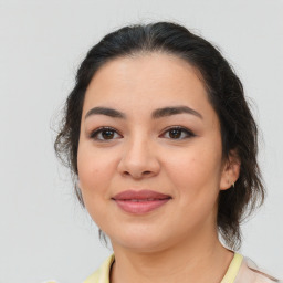 Joyful latino young-adult female with medium  brown hair and brown eyes