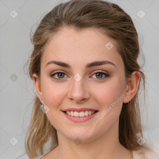 Joyful white young-adult female with medium  brown hair and grey eyes