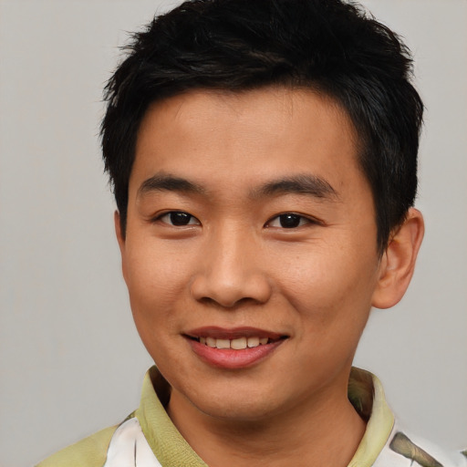 Joyful asian young-adult male with short  black hair and brown eyes