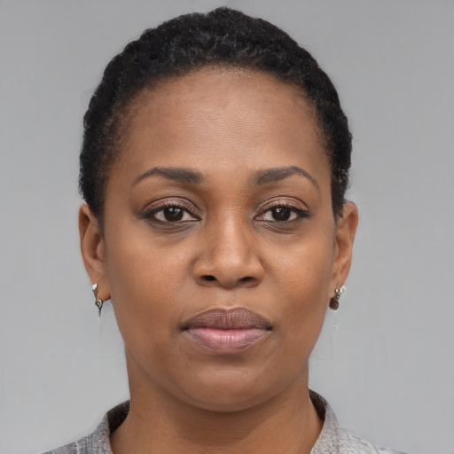 Joyful black young-adult female with short  black hair and brown eyes