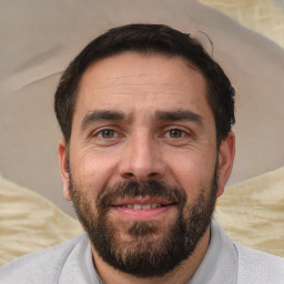 Joyful white adult male with short  brown hair and brown eyes