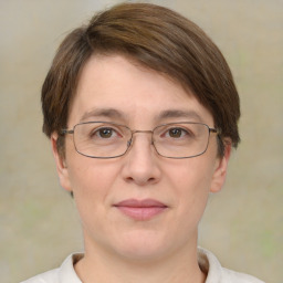 Joyful white adult female with short  brown hair and brown eyes