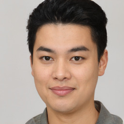 Joyful asian young-adult male with short  black hair and brown eyes