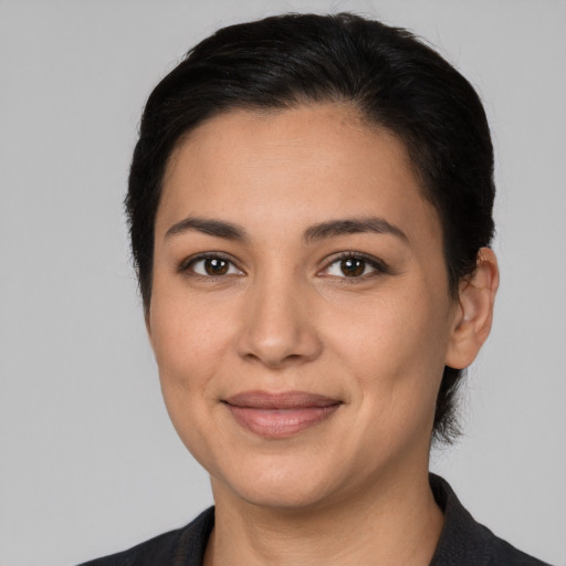 Joyful latino young-adult female with medium  black hair and brown eyes