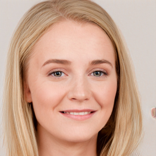 Joyful white young-adult female with long  brown hair and blue eyes