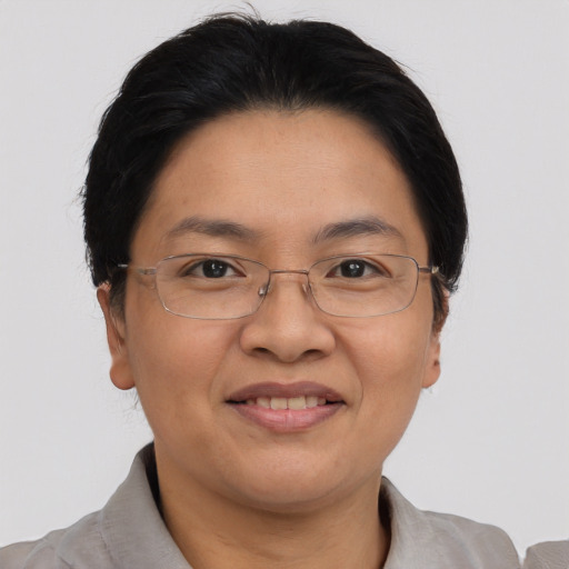 Joyful asian adult female with short  brown hair and brown eyes
