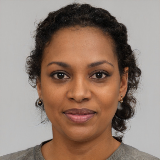 Joyful black young-adult female with medium  black hair and brown eyes