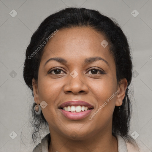 Joyful black young-adult female with long  black hair and brown eyes