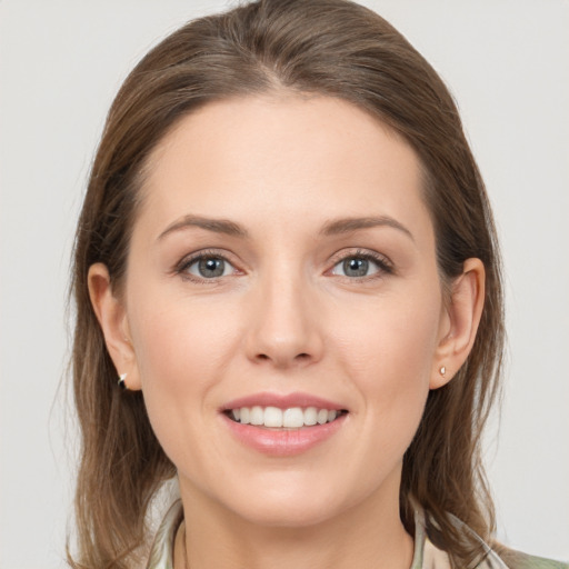 Joyful white young-adult female with medium  brown hair and grey eyes