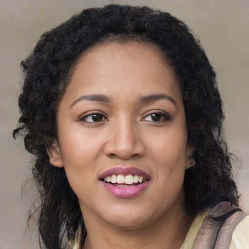 Joyful black young-adult female with long  brown hair and brown eyes