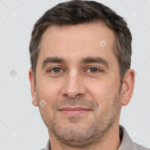 Joyful white adult male with short  brown hair and brown eyes