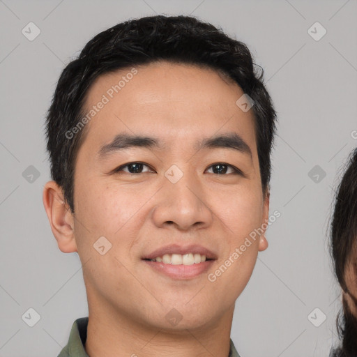 Joyful asian young-adult male with short  black hair and brown eyes