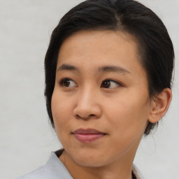 Joyful asian young-adult female with medium  brown hair and brown eyes