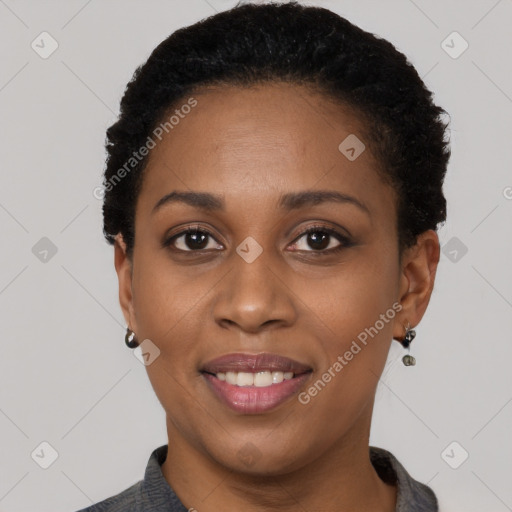 Joyful black young-adult female with short  black hair and brown eyes