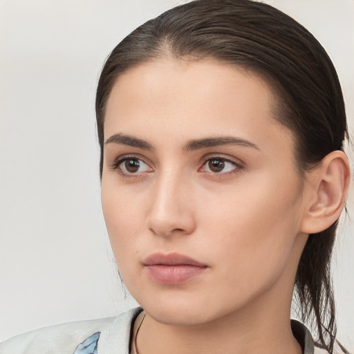 Neutral white young-adult female with long  brown hair and brown eyes