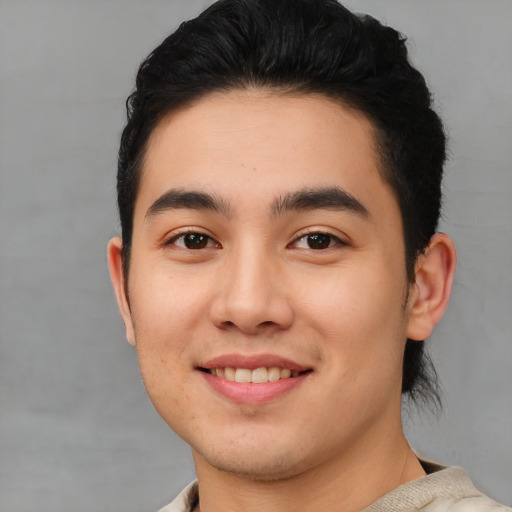 Joyful white young-adult male with short  black hair and brown eyes