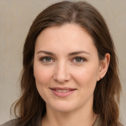 Joyful white young-adult female with long  brown hair and green eyes