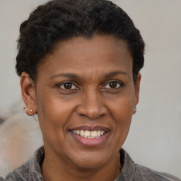 Joyful black adult female with short  brown hair and brown eyes