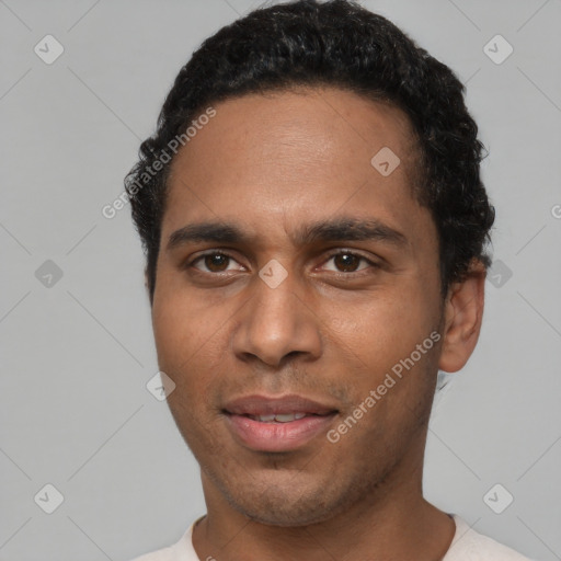 Joyful black young-adult male with short  brown hair and brown eyes