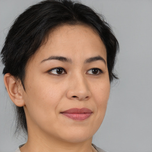Joyful asian young-adult female with medium  brown hair and brown eyes