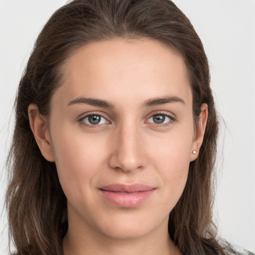 Joyful white young-adult female with long  brown hair and grey eyes