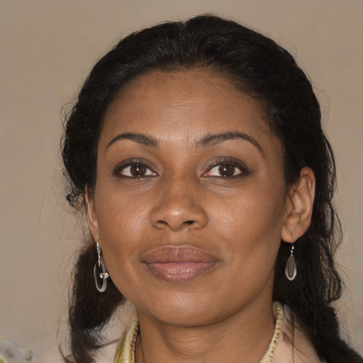 Joyful black adult female with medium  brown hair and brown eyes