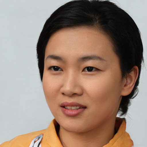 Joyful asian young-adult female with medium  black hair and brown eyes