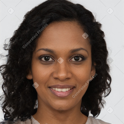 Joyful black young-adult female with long  brown hair and brown eyes