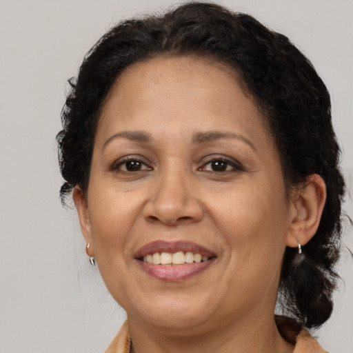 Joyful black adult female with medium  brown hair and brown eyes