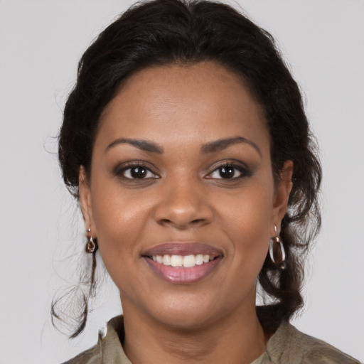 Joyful black young-adult female with medium  brown hair and brown eyes