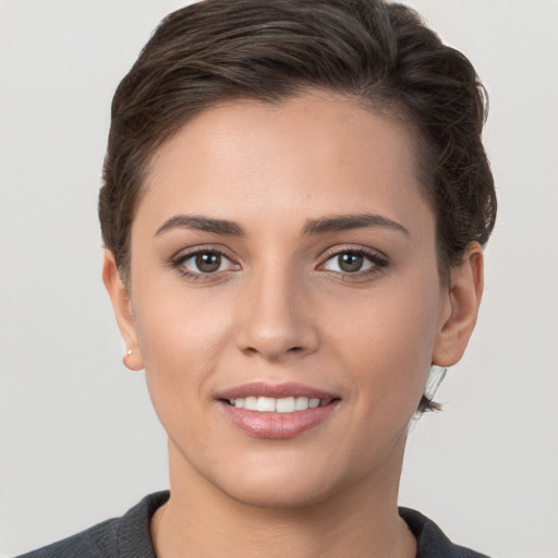 Joyful white young-adult female with short  brown hair and brown eyes