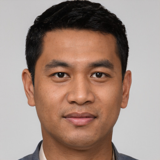 Joyful asian young-adult male with short  black hair and brown eyes