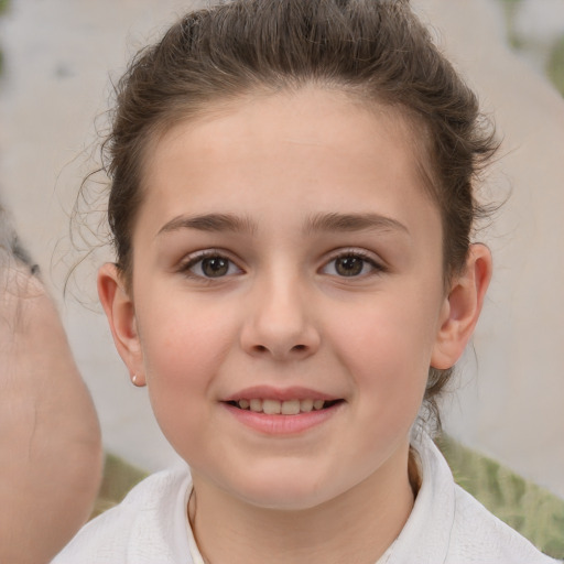 Joyful white child female with short  brown hair and brown eyes