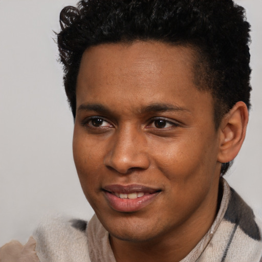 Joyful black young-adult male with short  brown hair and brown eyes