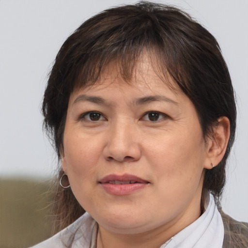 Joyful white adult female with medium  brown hair and brown eyes