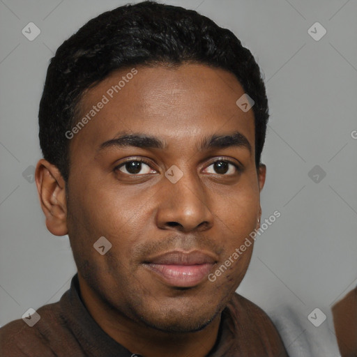Joyful black young-adult male with short  black hair and brown eyes
