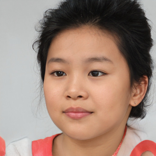 Joyful asian child female with medium  brown hair and brown eyes