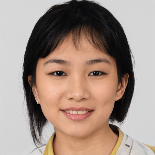 Joyful asian young-adult female with medium  black hair and brown eyes