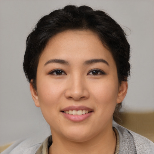 Joyful asian young-adult female with short  brown hair and brown eyes